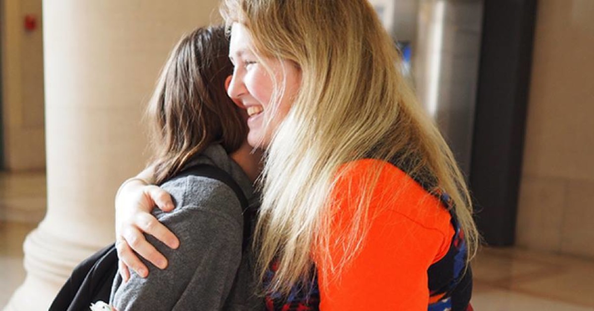 Isabel Lloyd hugs a fellow MIT student