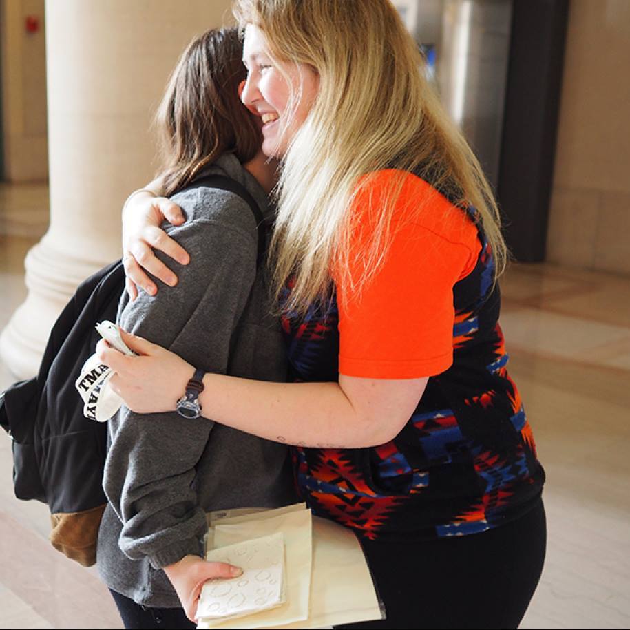 Isabel Lloyd hugs a fellow MIT student